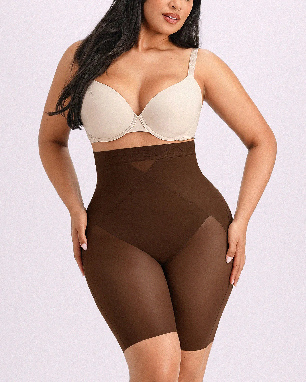 Model wearing brown high-waisted shorts engineered with targeted X-mesh belly flattening and airy cooling comfort.