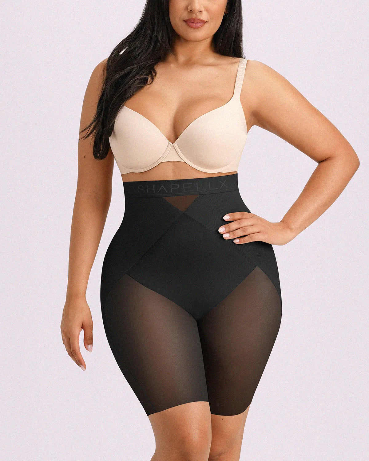 Model wearing black high-waisted shorts engineered with targeted X-mesh belly flattening and airy cooling comfort.