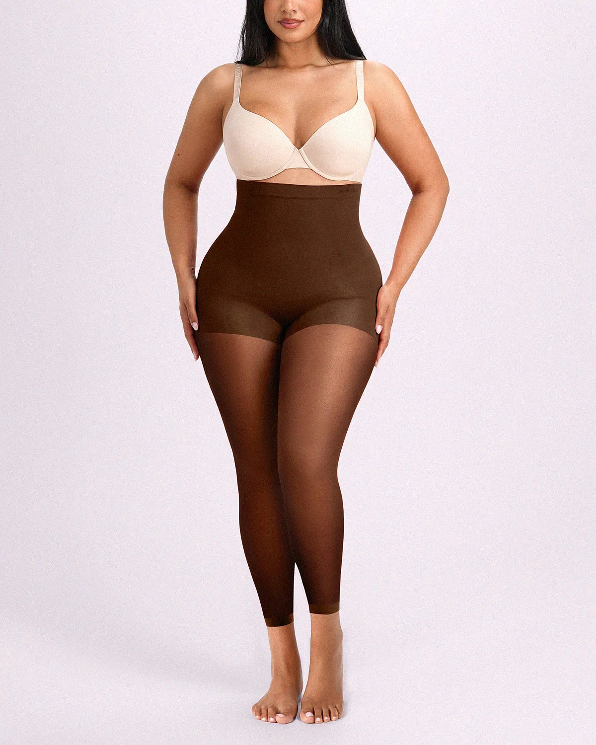 Model facing front in brown shaping tights engineered with targeted midsection flattening and all-day breathable comfort